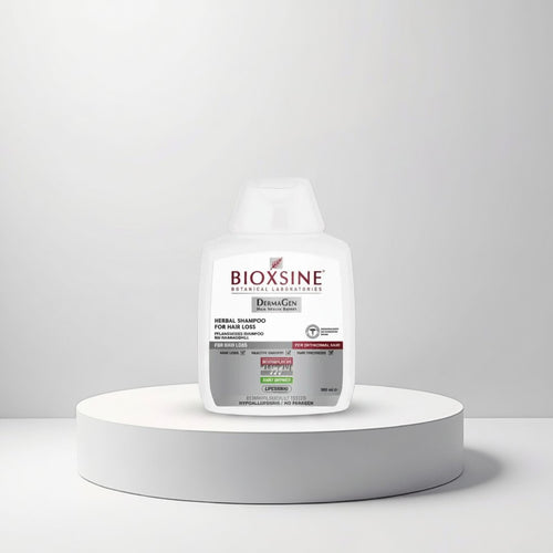 Cosmetigo.be Bioxsine Herbal Shampoo for Hair Loss, 300ml bottle on a white pedestal. Formulated with DermaGen for healthy growth and hair thickness.