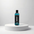 Gummy Professional Eau De Cologne Savour in a clear bottle with blue liquid, presented on a white pedestal.